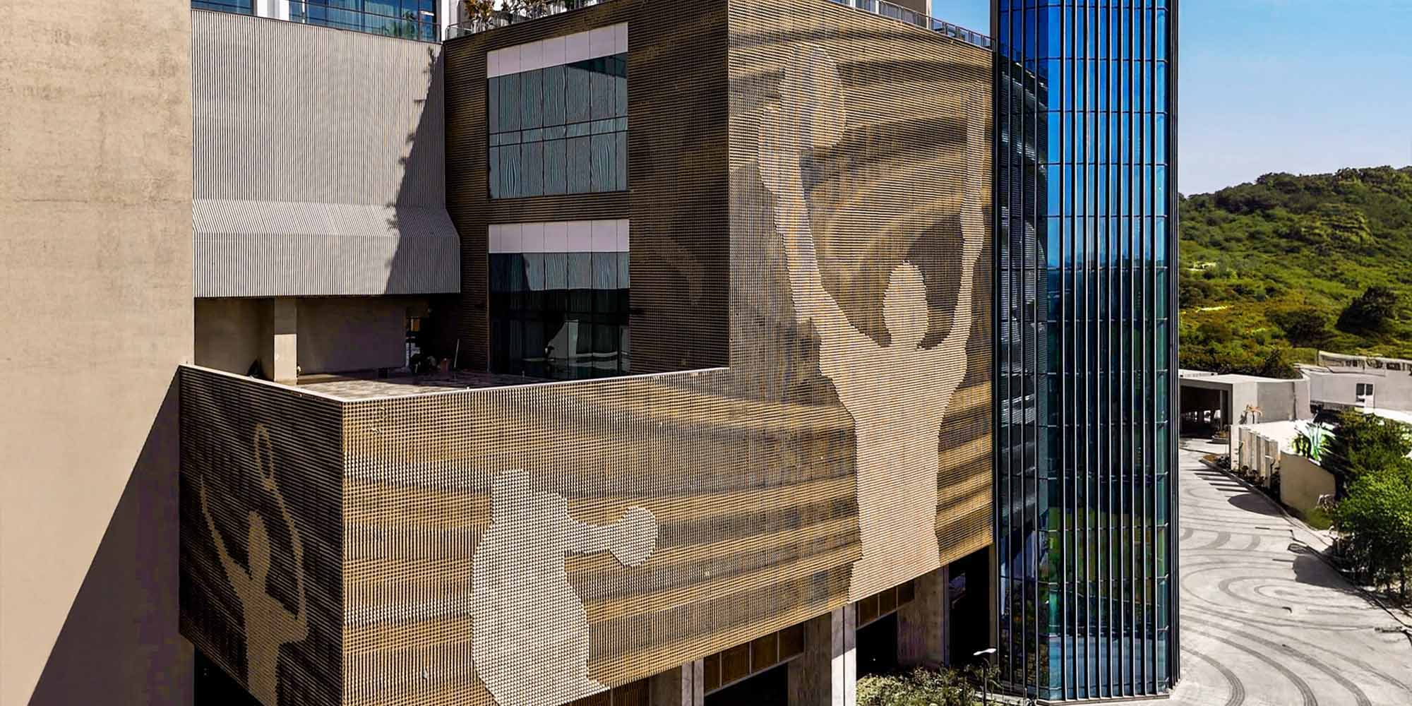 Perforated metal facade on commercial building exterior in India with geometric design and architectural elevation