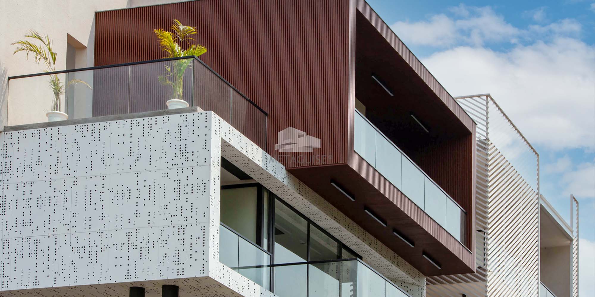 Completed MetaSequin parametric metal facade on Indian commercial building showing shimmer gradient and light reflection