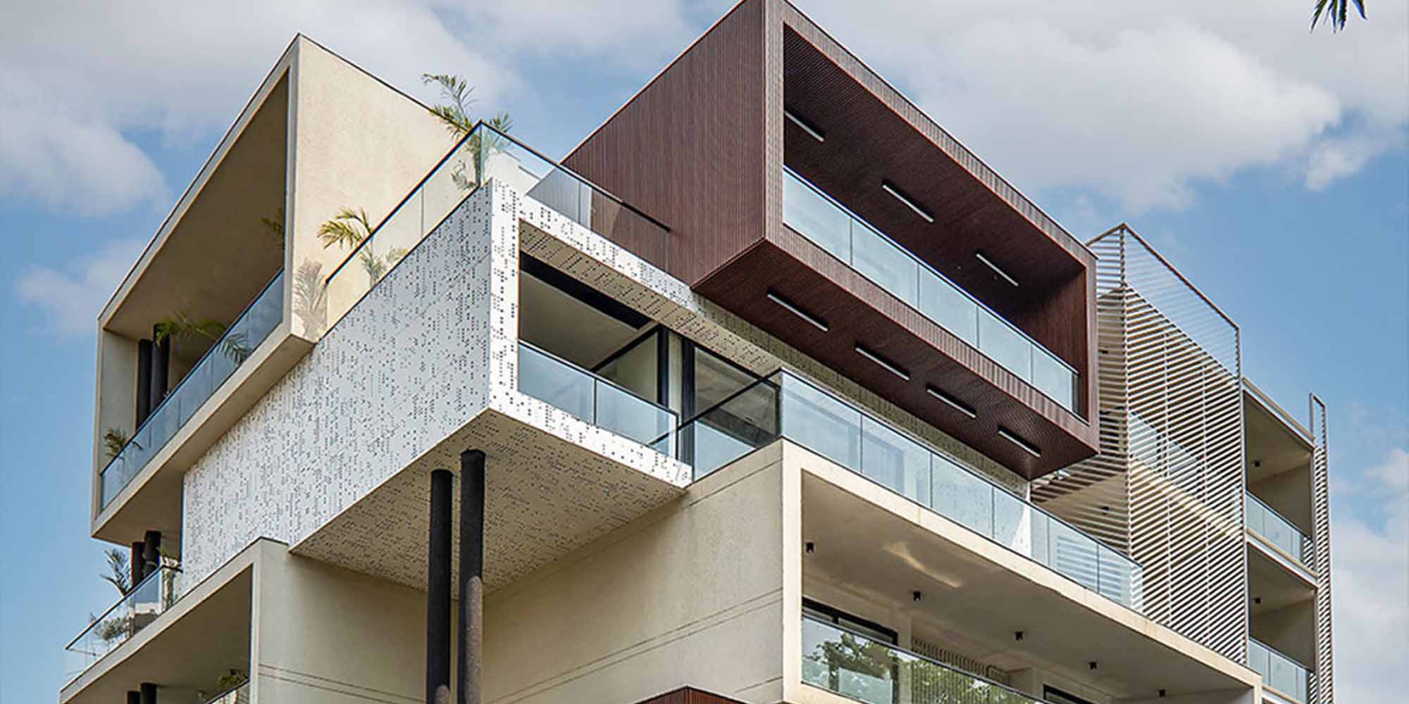 Modern villa exterior design trends India 2026 — glass facade with metal cladding and seamless indoor outdoor integration