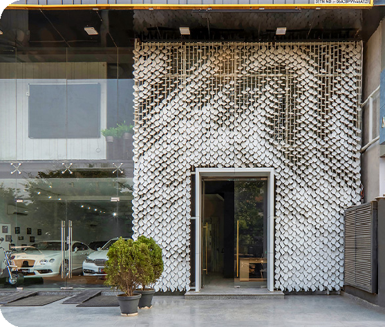 An image of the facade of Metaland featuring the white MetaSequin panels forming the tree of knowledge pattern